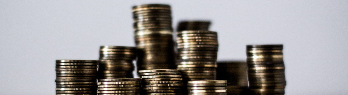 Stacks of coins of various heights on a white background