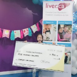Little heroes birthday party: little girl presenting cheque for CLF