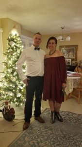Now much healthier and at a safer weight, heather stands in a deep red dress, beside her husband in a white shirt and bowtie, ready to attend an event. In the background of their home, a christmas tree is brightly lit beside them. In essence, this photo proves that Heather did not let her liver disease define her. 